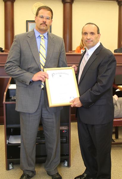 Freeholder Director Arnone (right) presents John Tobia, Monmouth County Director of Public Works and Engineering, with a proclamation recognizing Public Works Week (May 19-25).